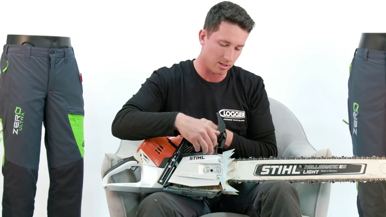 Phil, a working arborist, shows the path bar oil takes: from the pump inside the saw, through a hole in the bar, onto the chain