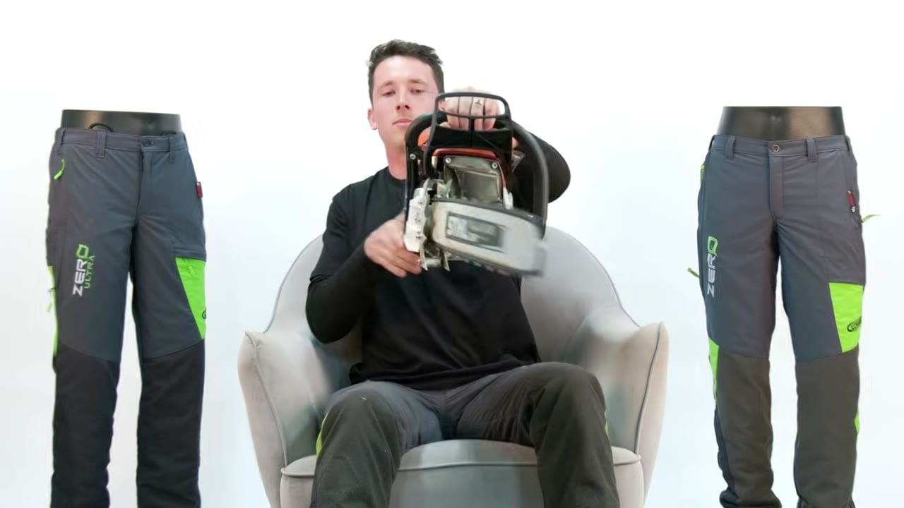 Phil turns a chainsaw to show where the bar oil goes in